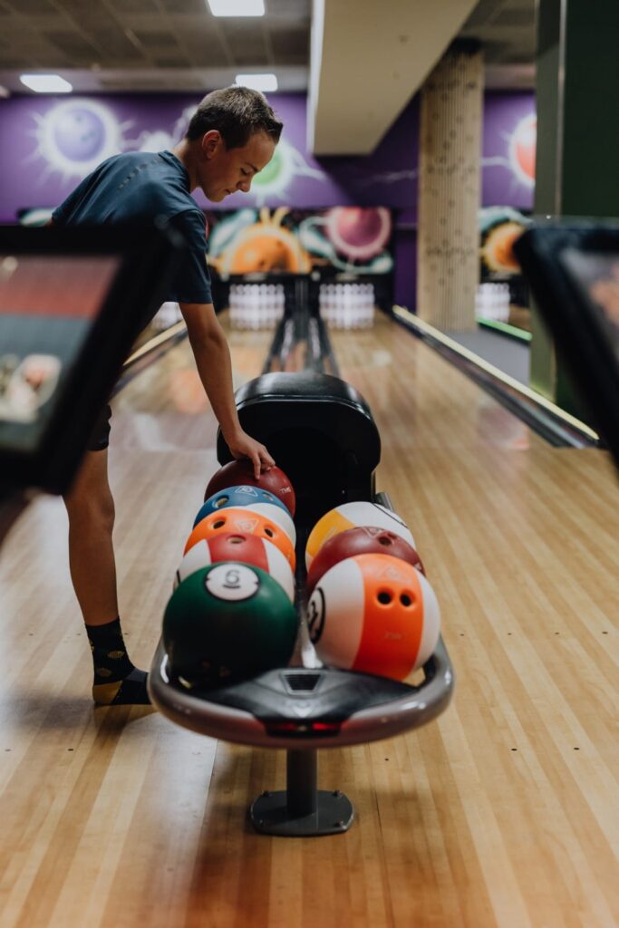 lets-go-bowling-player-selecting-ball-from-rack