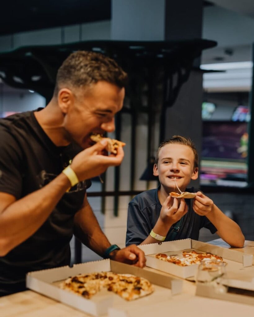 man-and-boy-eating-pizza-at-pappa-g's